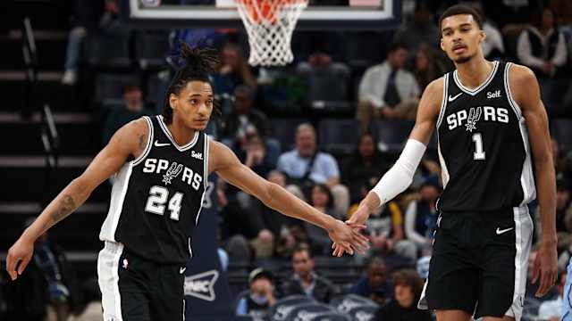 Jan 2, 2024; Memphis, Tennessee, USA; San Antonio Spurs guard Devin Vassell (24) reacts with center Victor Wembanyama (1) during the second half against the Memphis Grizzlies at FedEx Forum.